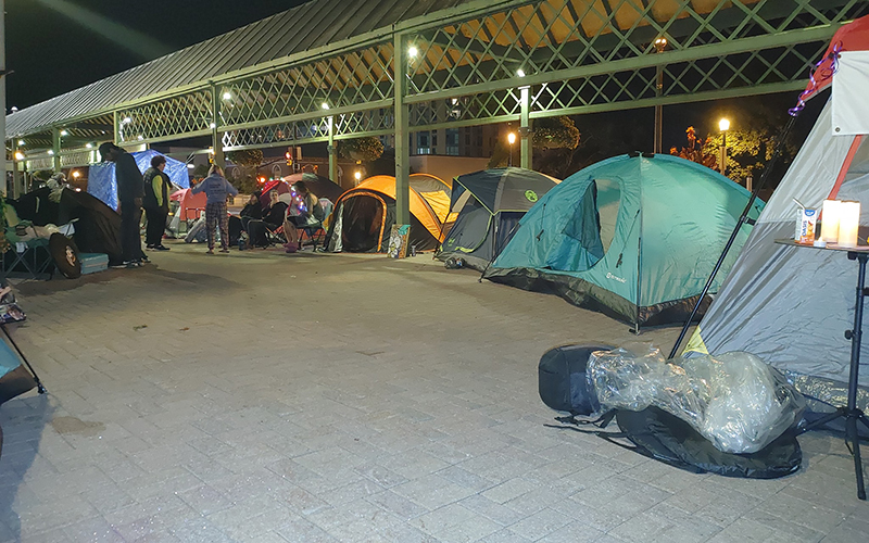 By midnight, about twenty tents faced City Hall, shouting in silence.